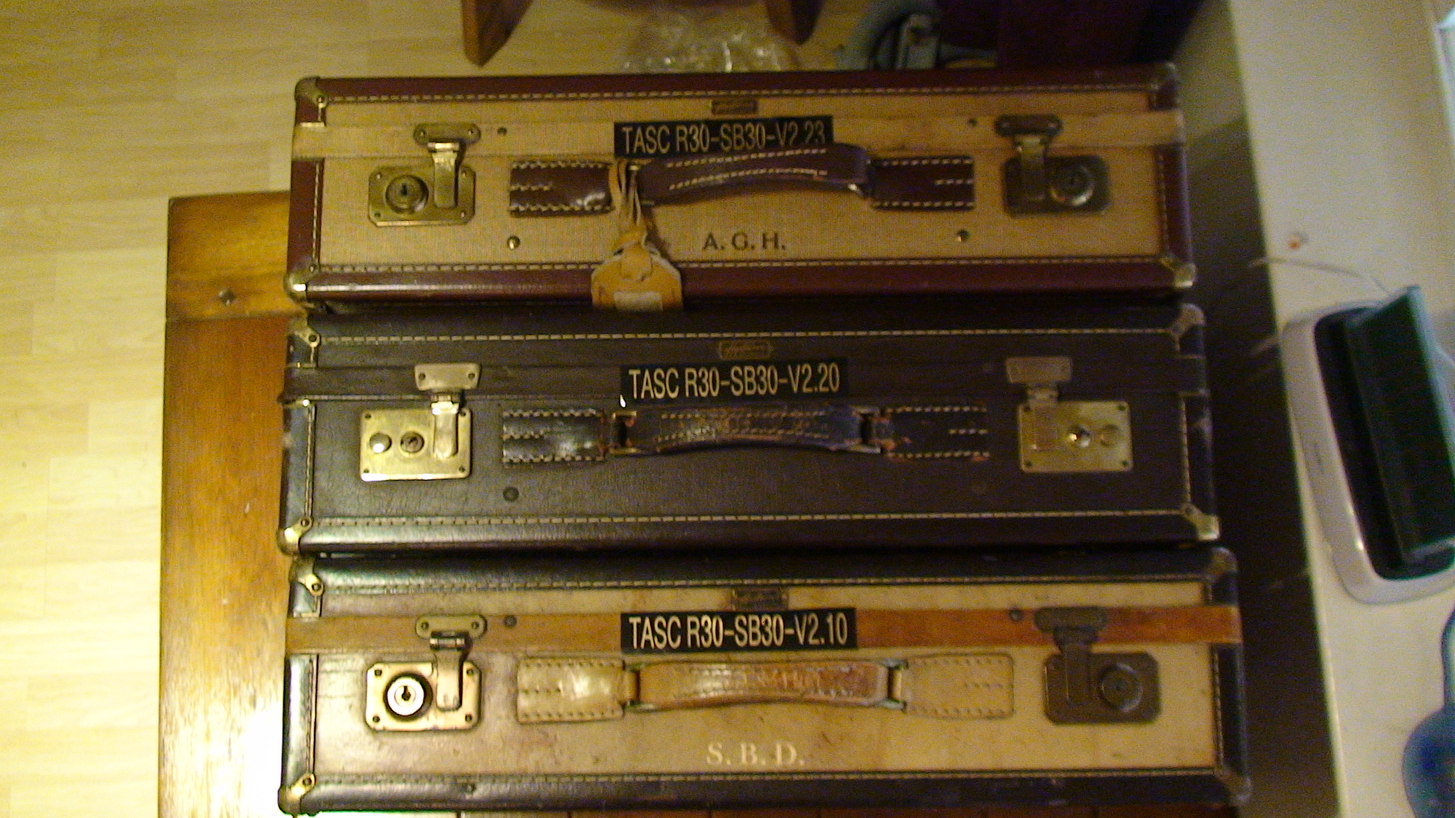 Rear identification labels on three TASC units shown together for comparison.